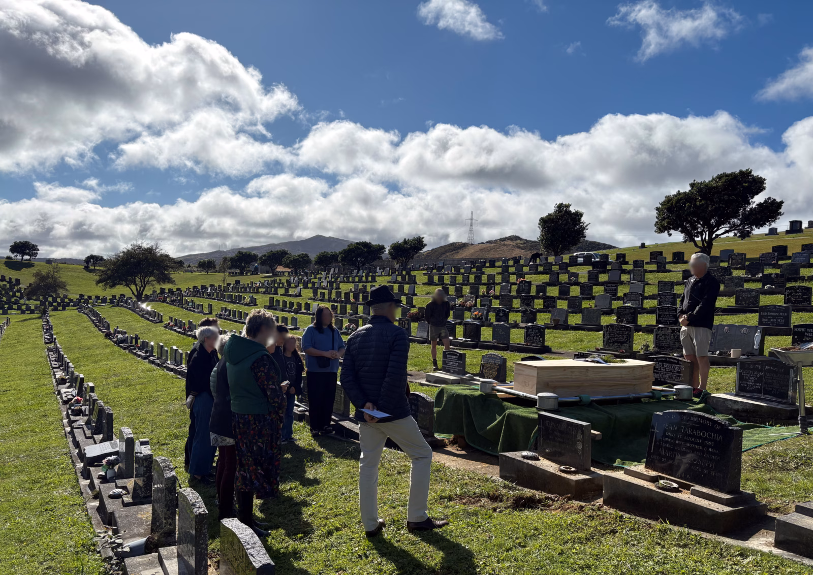 People gather for an interment at Makara Cemetery